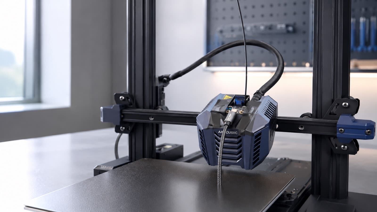 A printer toolhead drawing a strand of filament above the build plate